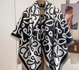 Cashmere design scarf with heart pattern, black and white color scheme.