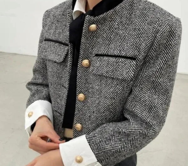 Woman wearing Grey Tweed Cropped Jacket with buttons, a stylish outerwear choice.