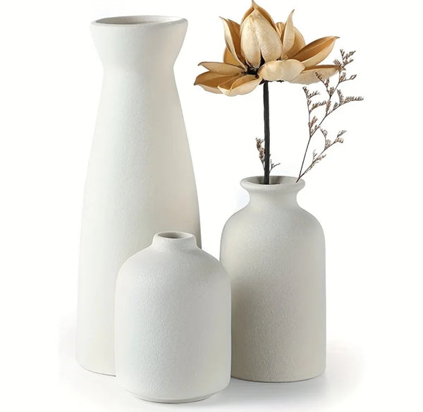 Set of 3 ceramic Vase pots: Three white vases, each with a single flower. A beautiful display of elegance and nature.