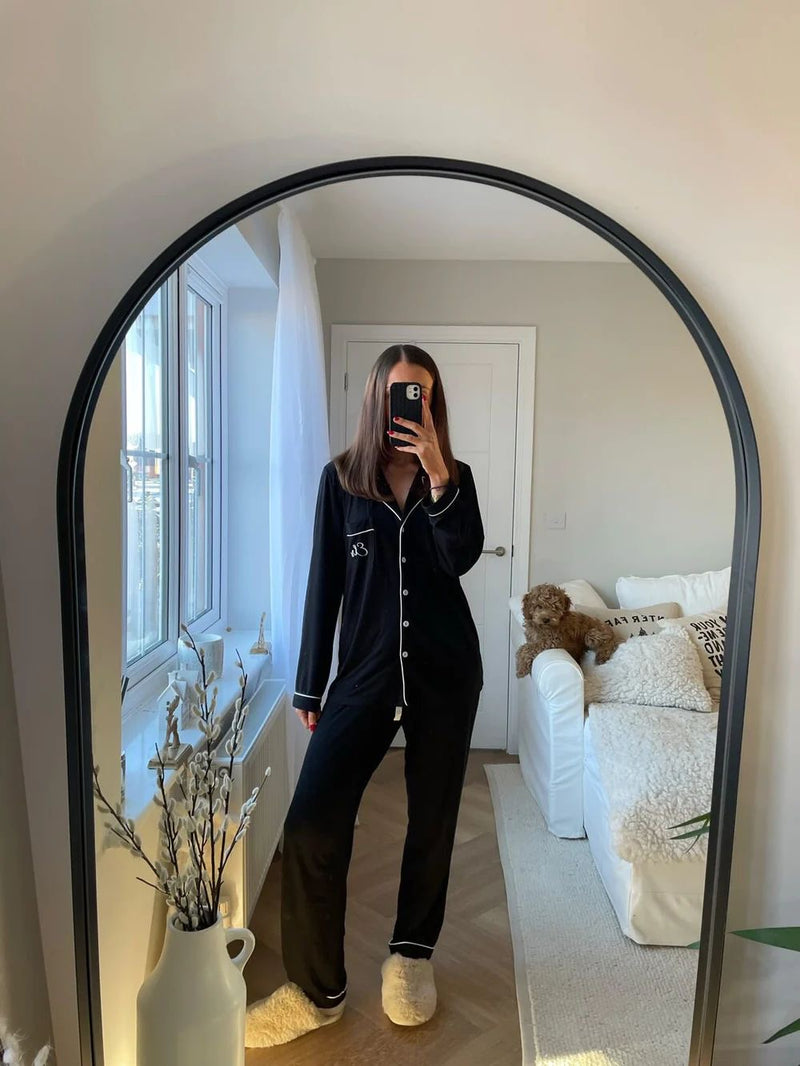 Woman in pajamas taking a mirror selfie. Weekend bundle pyjamas and bag gift worth over £80