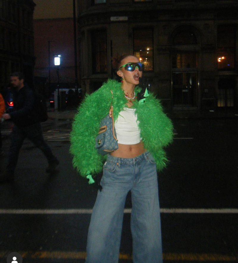 Woman in trendy Green Faux Fur Coat and sunglasses.