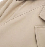 Cropped Trench Coat: Light tan trench coat made from a lightweight fabric