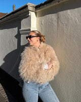 Stylish woman in fluffy coat by Faux Sheep Jacket Beige