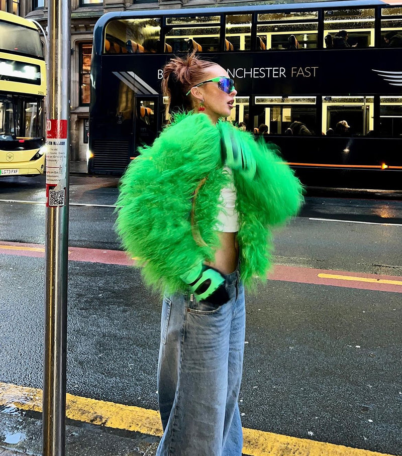 Fashionable woman in a Green Faux Fur Coat and jeans