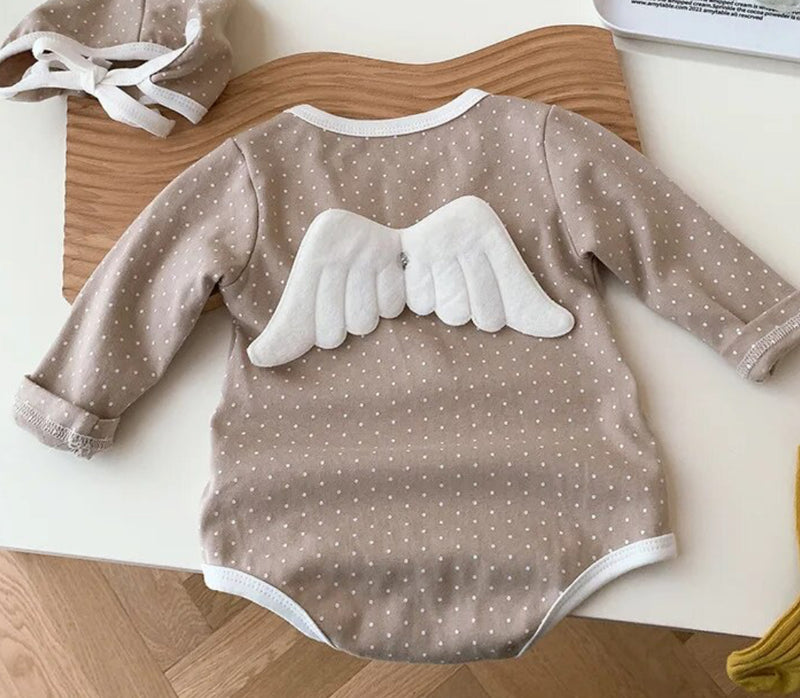 Angel wings Baby Grow Polka Dot' - An adorable baby dressed in a romper with angel wings, featuring charming polka dot patterns.