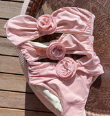 Pink Rose Swimsuit: A stylish pink swimsuit adorned with a delicate flower design.