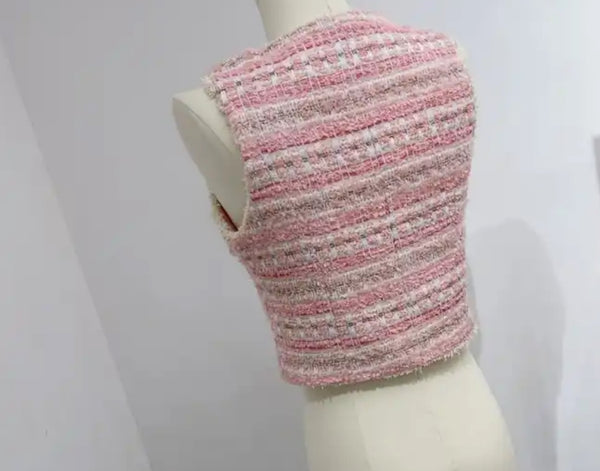 Pink Tweed Waistcoat: Stylish pink and white knitted vest displayed on mannequin.