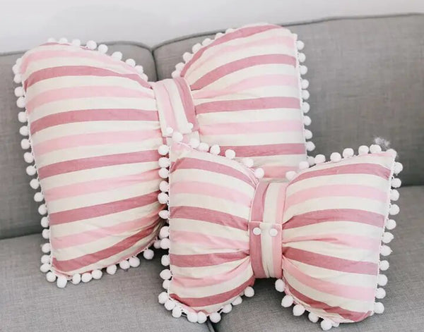 Adorable bow pillow in blush pink, ideal for enhancing the cozy and stylish vibe of your living space
