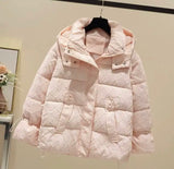 A longline Down Puffer Jacket in pink, elegantly hanging on a wall.