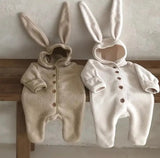 Adorable Bunny Baby Onsies displayed on bench