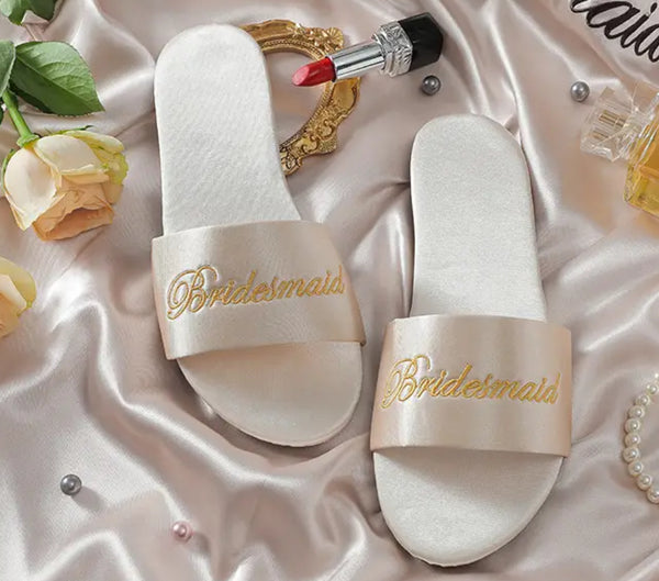 Bride/Bridesmaid Satin Slippers: Elegant slippers with gold lettering and pearls, perfect for bridesmaids.