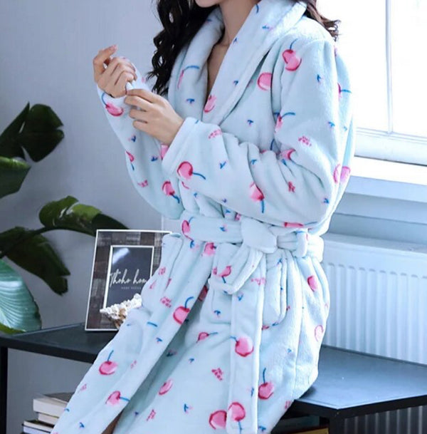 A woman in a blue bathrobe with pink flowers, wearing the Blue and Pink Cherry Bath Robe