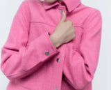 A woman in a pink coat posing. Cropped pocket soft jacket, a stylish and trendy fashion item.