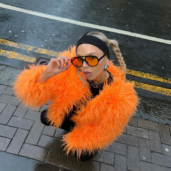 Woman in stylish Orange Faux Fur Jacket and sunglasses