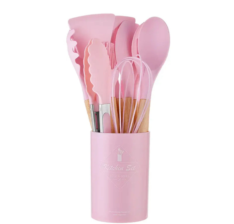 A cup filled with pink silicone kitchen utensils, including spatulas, spoons, and tongs. Product name: Pink 12Pcs Cooking Utensils.