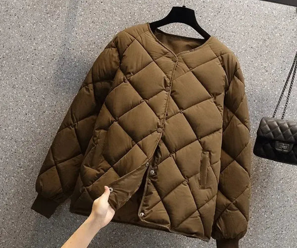 A woman showcasing the Padded Quilted Jacket, a stylish brown outerwear with a quilted design