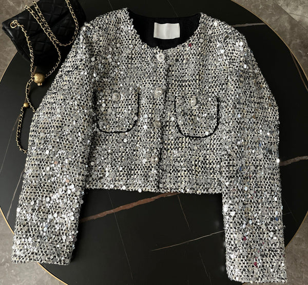 A stylish Sequin Tweed Short Jacket paired with a matching purse, perfect for a chic and glamorous look