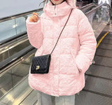 The Down Puffer Jacket Longline displayed on a woman wearing a pink coat and carrying a black bag