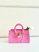 Handbag flower vase: Pink purse holding white tulip