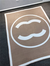 Colorful CC throw rug featuring company logo