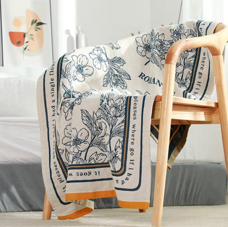 Nordic Style Floral Towel on a chair with a blanket and bed