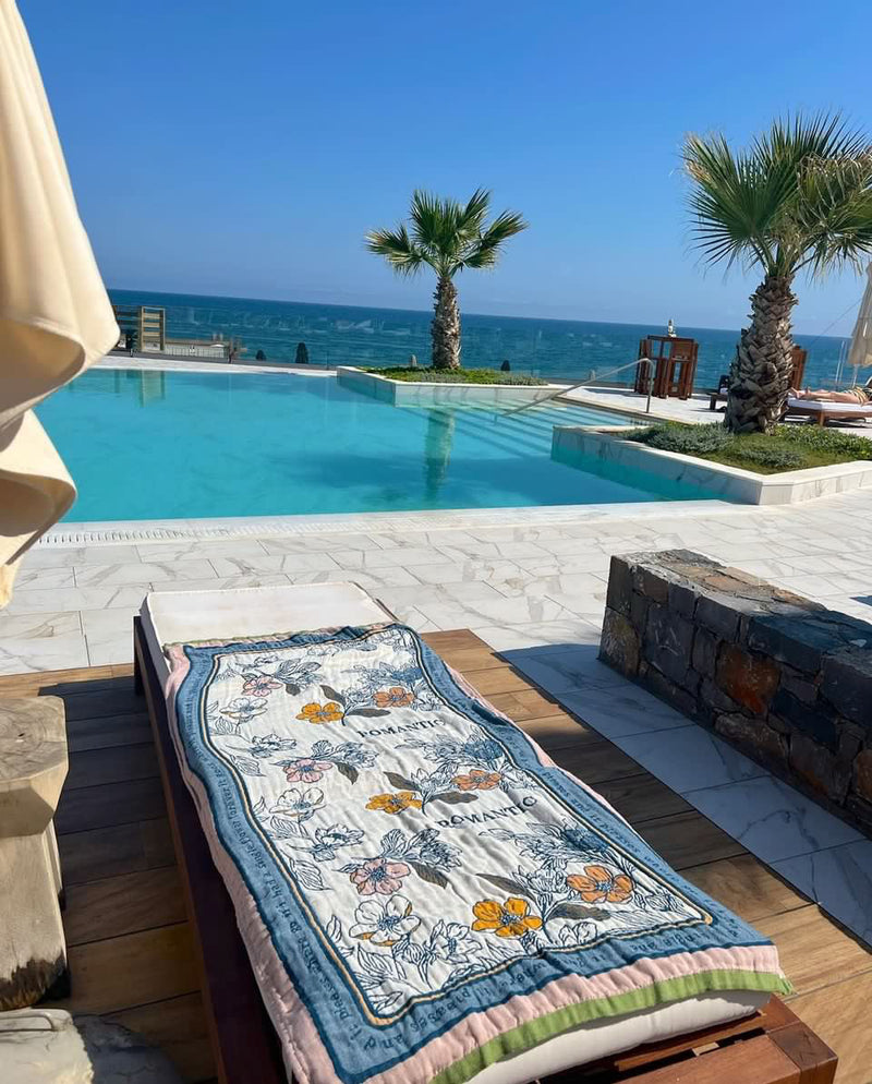Nordic Style Floral Towel resting on deck near pool, perfect for beach days