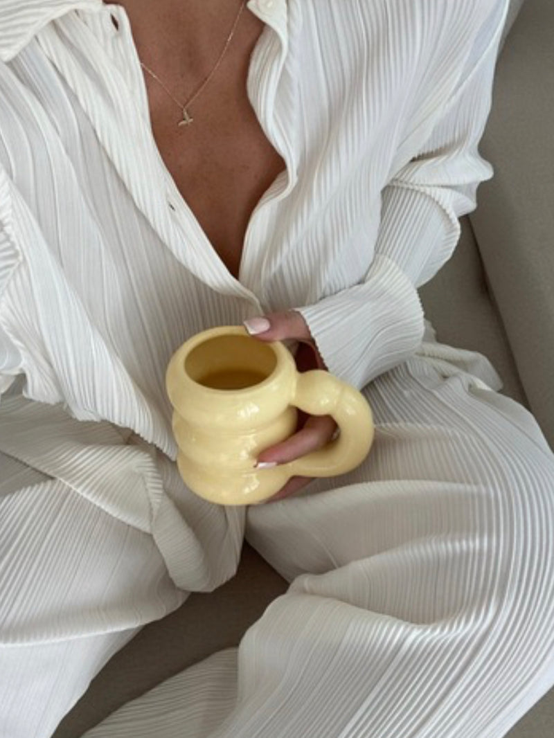 a women holding bubble mug